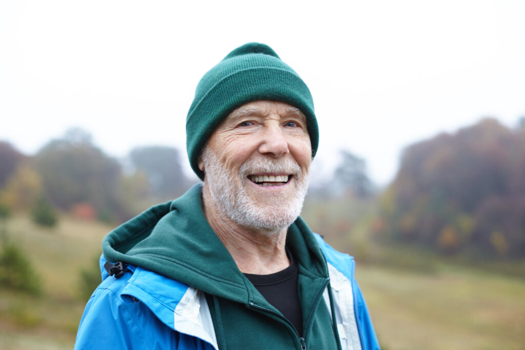 Older man smiling in countryside