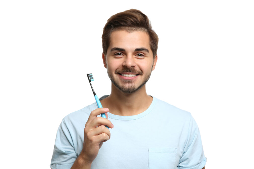 young man with toothbrush on white background