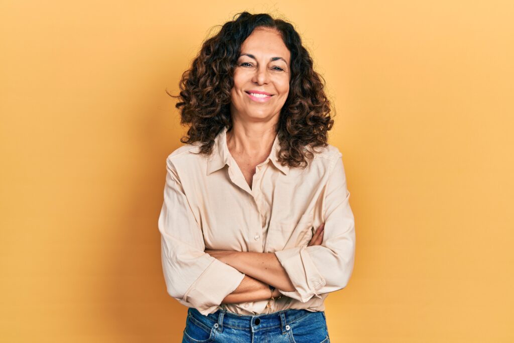 Woman smiling on yellow background