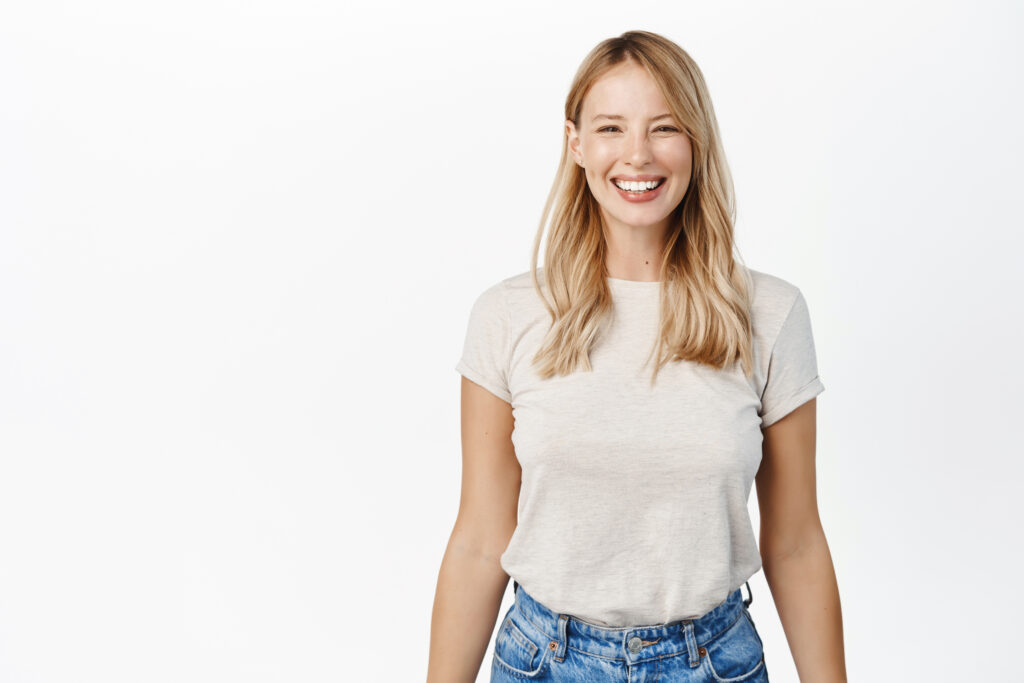 Smiling woman in white tee shirt and jeans