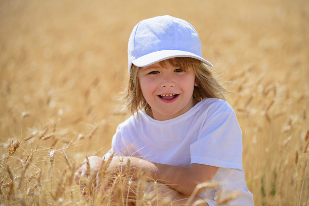 Child smiling in wheat field