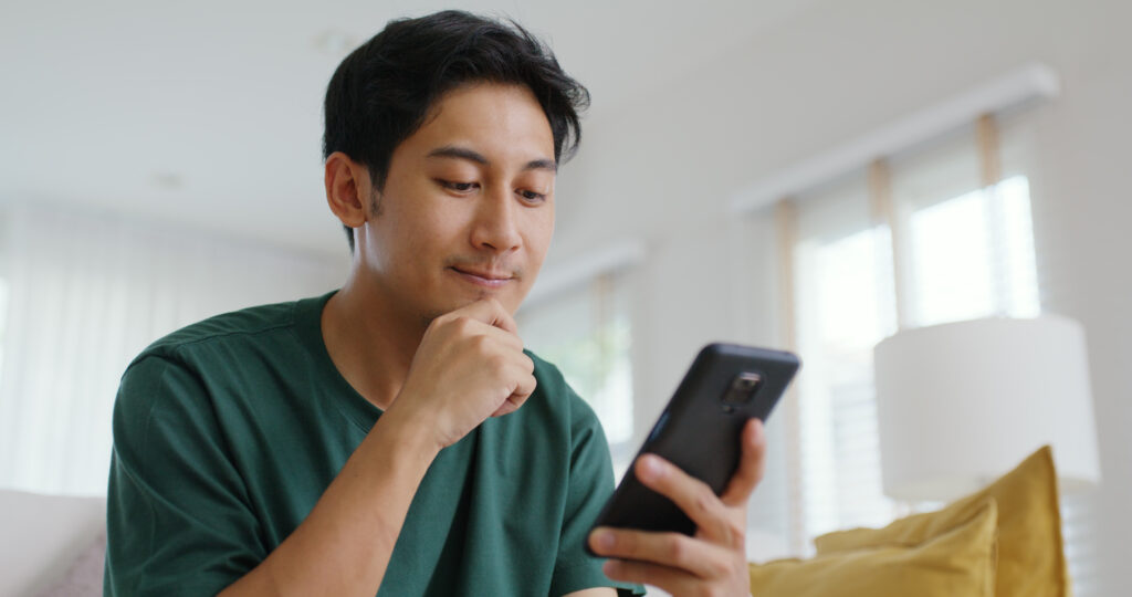 Man looking at phone happy