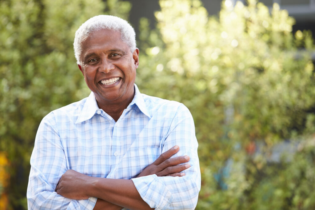 Smiling senior African American man with arms crossed