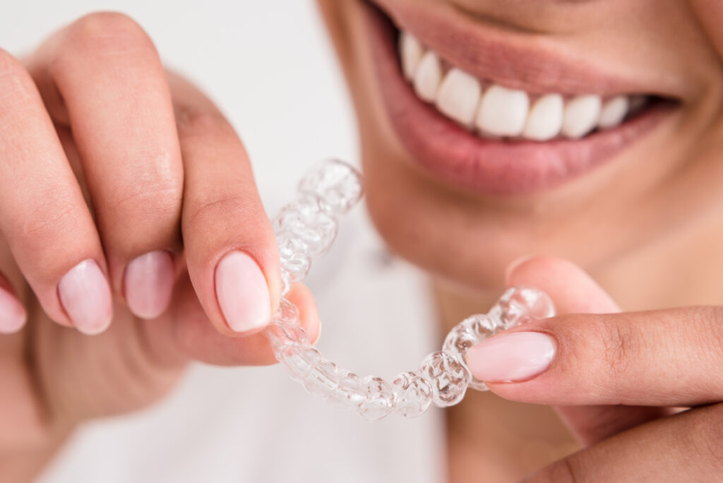 woman beautiful smile holding a transparent mouth guard